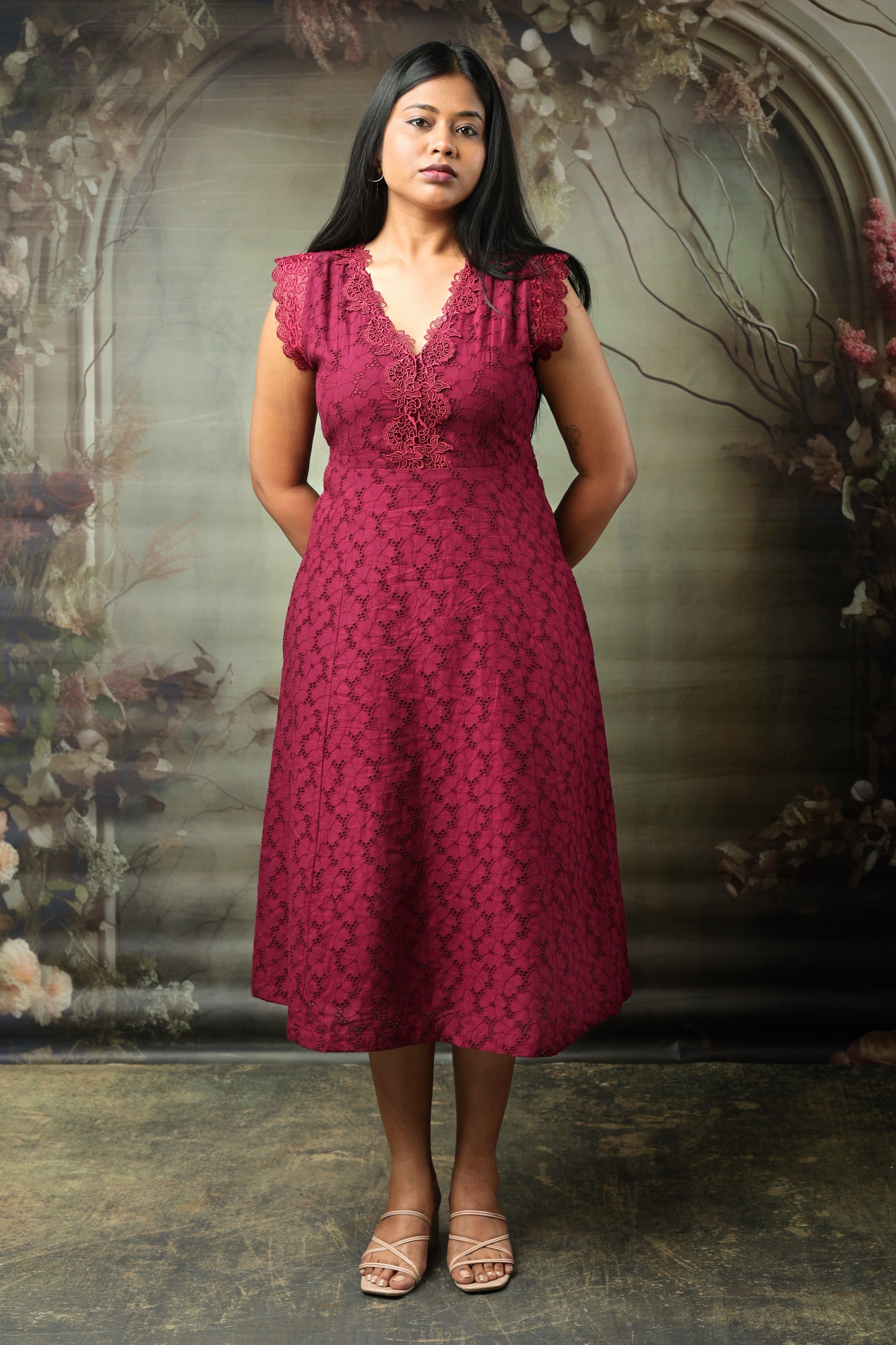 Woman wearing a maroon cotton midi dress with lace details