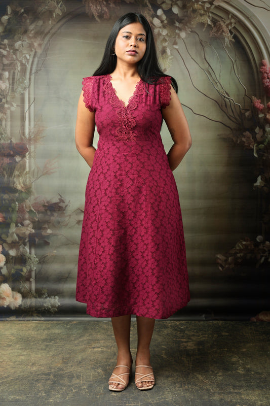 Woman wearing a maroon cotton midi dress with lace details