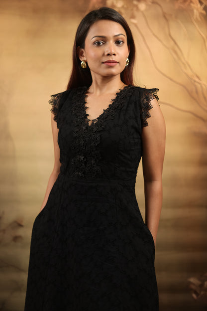 Close up of petite schiffli black petite midi dress with lace