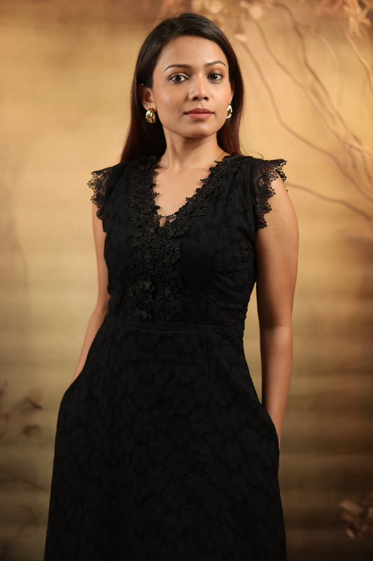 Close up of petite schiffli black petite midi dress with lace